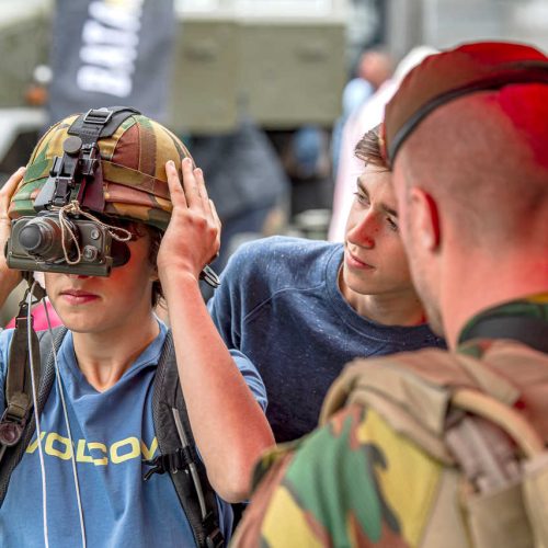 Brussels liberation day a child tries on a military helmet